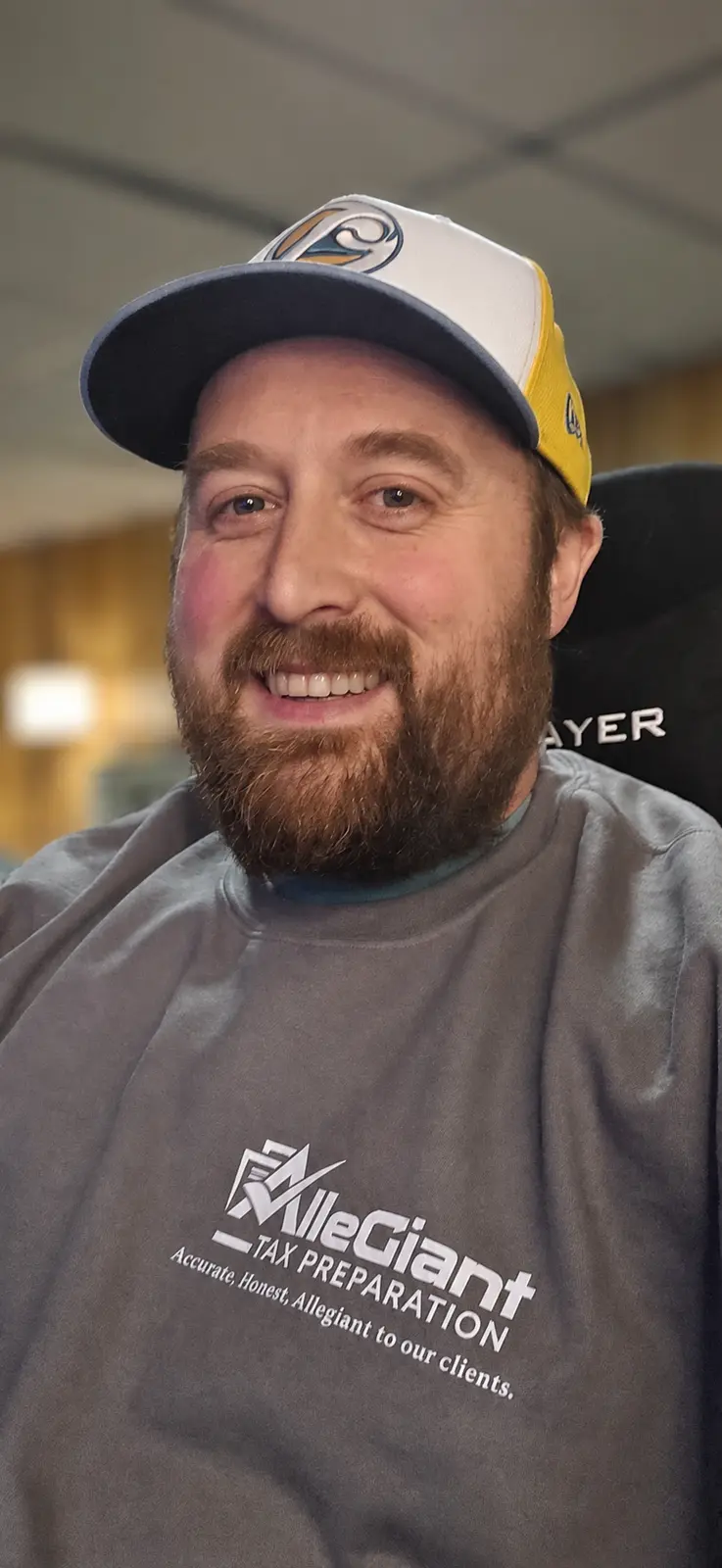 Kyle Mura, owner of Allegiant Tax Preparation, wearing an Allegiant shirt